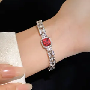 Macro view of a luxurious silver-toned bracelet featuring a square red zircon centerpiece
