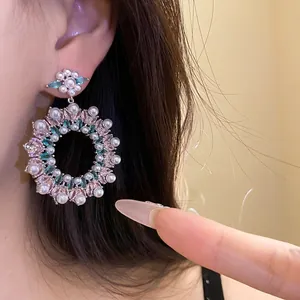 Elegant silver stud earrings with pearls and colorful zircons in floral wreath design