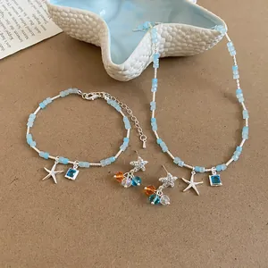 Detail view of blue starfish pendant necklace, bracelet and earrings jewelry set