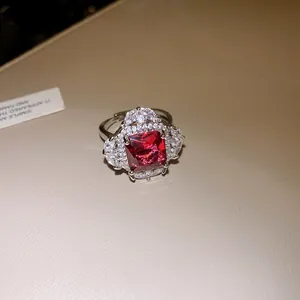 Close-up detail of an elegant red square zircon ring with sparkling diamond-like settings