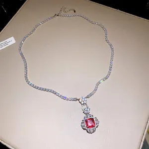 Detailed view of luxury square red zircon pendant on a sparkling tennis chain necklace