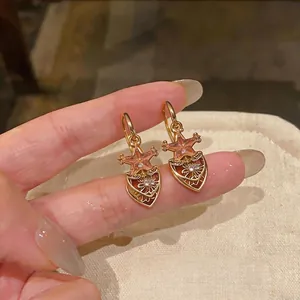 Elegant gold-plated star and filigree heart drop earrings featuring pink zircon stones