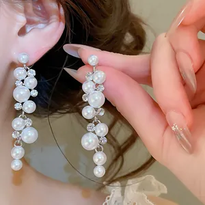 Macro view showing the intricate detail of elegant long dangle resin pearl earrings