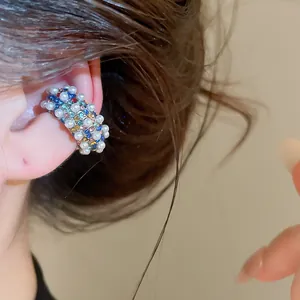 Vintage C-shaped ear cuff featuring colorful rhinestones and elegant pearls close-up