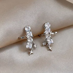 Close-up detail of silver star ear cuffs featuring sparkling clear cubic zirconia stones.