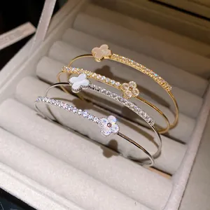 Macro detail shot of four-leaf clover bangles with sparkling zircon pave in jewelry box