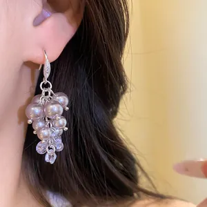 Elegant close-up view of French retro style pearl and zircon tassel drop earrings on ear