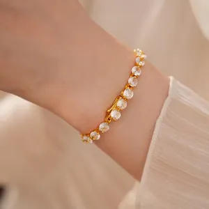Elegant 14k gold plated bracelet with sparkling round zircons on a woman's wrist