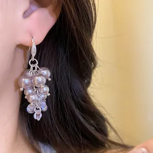 Close-up detail of French vintage tassel earrings with grey pearls and sparkling zircons