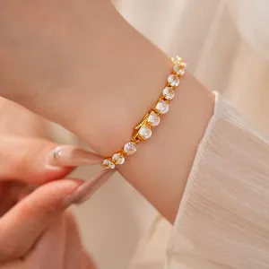 Elegant 14k gold plated bracelet featuring cubic zirconia stones on a woman's wrist