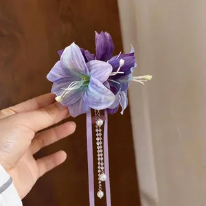 Elegant purple fabric flower hair clip with pearl tassels and ribbons in a fairy style