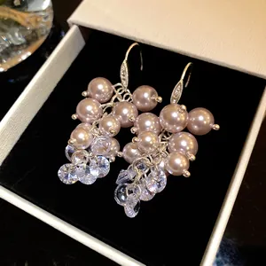 Close-up of French retro pearl and zircon tassel ear hooks in a premium jewelry box