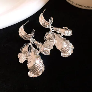 Close-up detail showing the intricate wrinkled texture of silver leaf pendant earrings