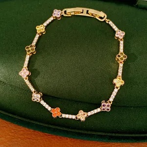 Close-up of 14k gold plated clover bracelet with multi-colored cubic zirconia stones