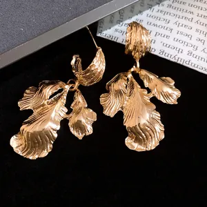 Detailed view of golden vintage-style metallic leaf-shaped dangle earrings for women