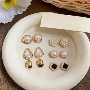 Elegant French style pearl stud earring set with gold finish and floral designs on tray