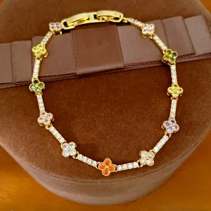 Detail shot of a 14k gold plated multi-colored zircon clover flower charm bracelet