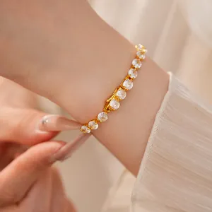Detailed close-up view of a 14k gold plated bracelet with sparkling white zircons