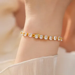 Close-up of 14k gold plated bracelet with sparkling cubic zirconia crystals on wrist.