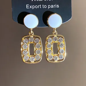 Elegant vintage gold-toned rectangular drop earrings with sparkly rhinestone clusters