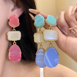 Close-up of retro palace style resin teardrop earrings with elegant marbled texture