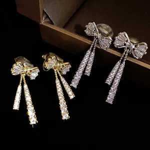 Sparkling zircon bow-knot dangle clip-on earrings in 14k gold plating finish