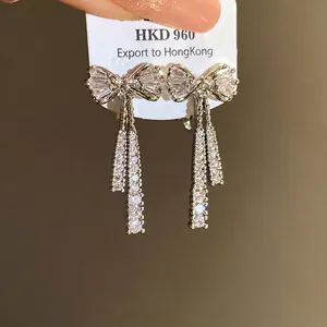 Elegant 14k gold plated bow-knot earrings featuring sparkling dangling cubic zirconia.