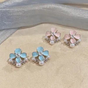 Detailed view of sweet enamel flower stud earrings featuring zircon and pearls