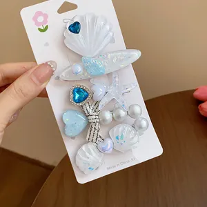 Elegant resin starfish and shell hair clip set with faux pearls and blue heart details.