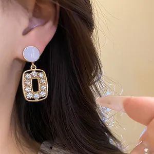 Elegant silver needle earrings with rhinestone-encrusted square hollow pendant