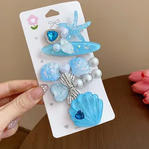 Detail of exquisite blue resin ocean-themed hair clips with starfish, shells and pearls