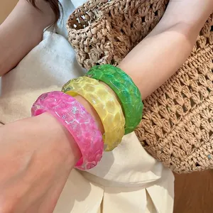 Colorful resin bangles with irregular hammered texture, perfect for beach vacation style