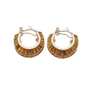 Luxurious gold-tone hoop earrings featuring amber baguette-cut crystals in a channel setting