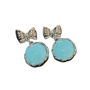 Korean style dreamlike light blue round bow-knot dangle earrings presented on white