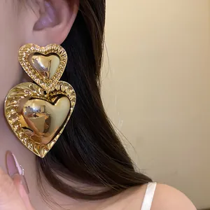 Retro exaggerated gold double heart pendant earrings with smooth mirror metallic finish