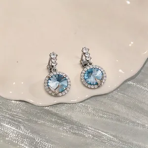 Eleganti orecchini pendenti tondi in cristallo blu con perni in argento e dettaglio