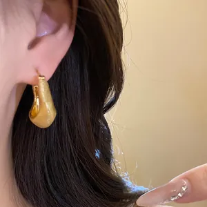 Detailed view of vintage 18K gold plated brushed finish chunky hoop earring for women