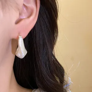 Macro view showing the 18K gold plated brushed texture on these elegant vintage earrings