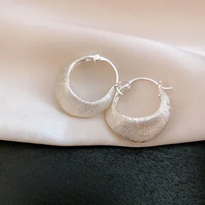 Close-up of vintage 18K gold plated brushed hoop earrings with unique satin finish.