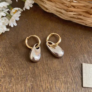 Detailed view of elegant French style water drop earrings with pleated silver texture
