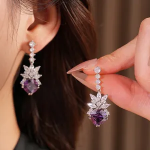 Elegant purple geometric drop earrings featuring sparkling cubic zirconia and silver needle