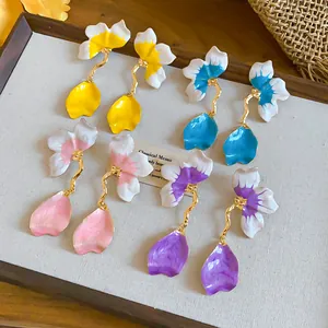 Detailed view of French-style petal tassel earrings in yellow, blue, pink, and purple colors