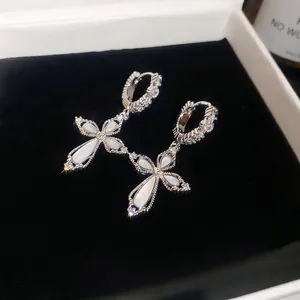 Elegant silver cross hoop earrings with white opal inlays and sparkling zirconia