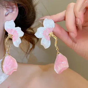 Exquisite French-style enamel petal tassel earrings with gold-finish wavy stems shown on model