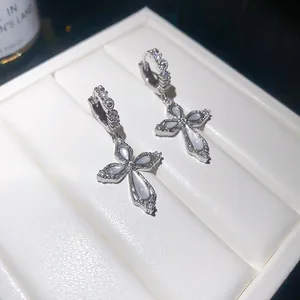 Elegant silver cross hoop earrings with sparkly zircons and shimmering shell inlay detail