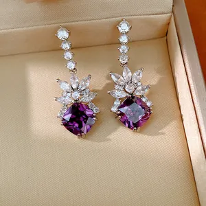 Elegant silver stud earrings with purple geometric stones and white cubic zirconia.