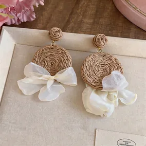 Handmade bohemian raffia grass drop earrings with elegant creamy white chiffon bow
