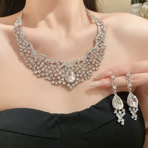 Exquisite close-up of sparkling rhinestone choker necklace and matching drop earrings on model