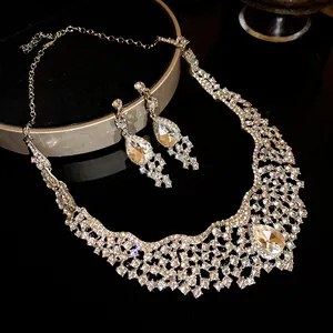 Close-up of sparkling rhinestone teardrop pendant necklace and earring jewelry set