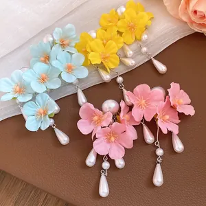 Detailed view of colorful floral tassel earrings with elegant pearl pendants